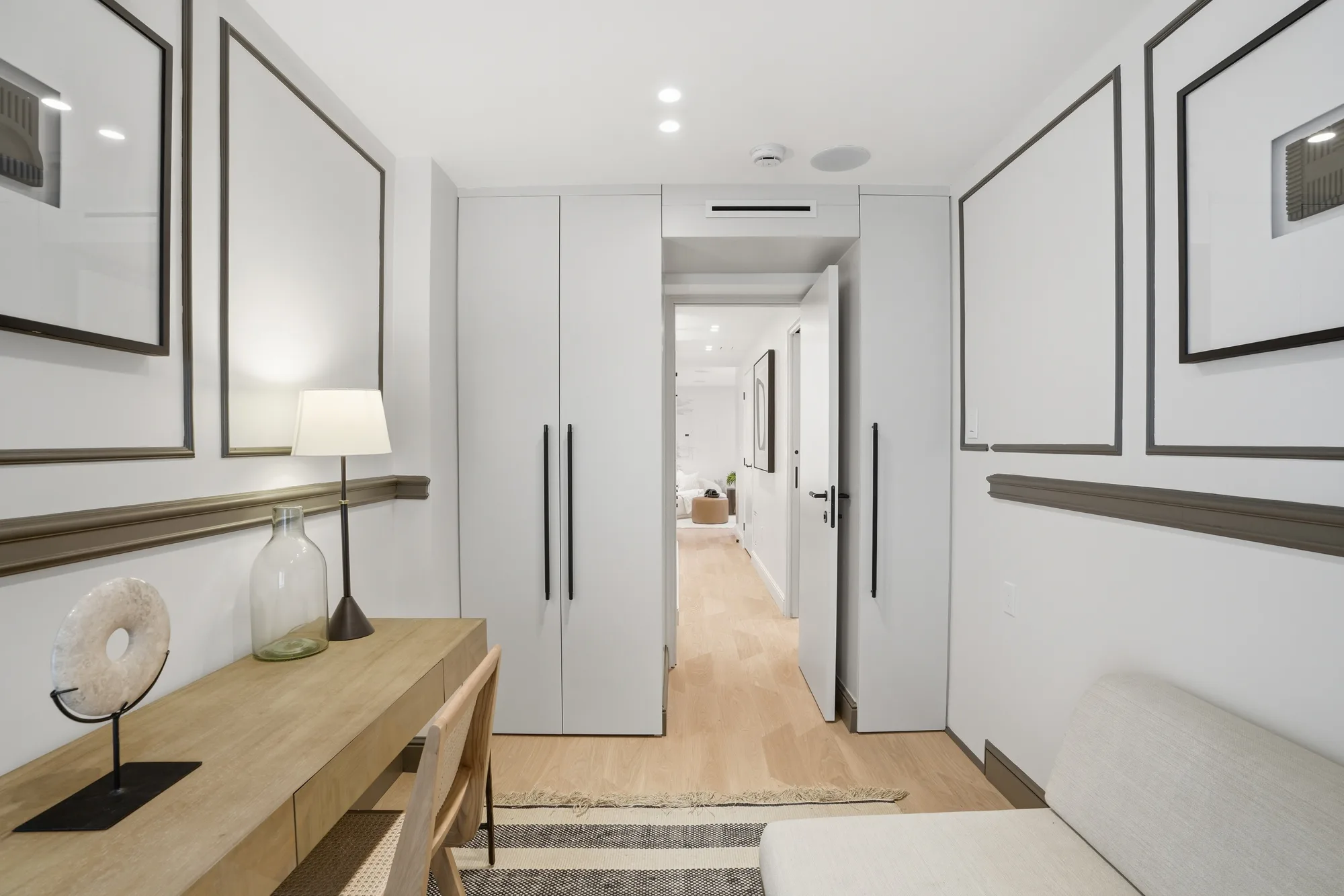 Third-floor bedroom with oak desk and gallery wall at Casa Ulivo