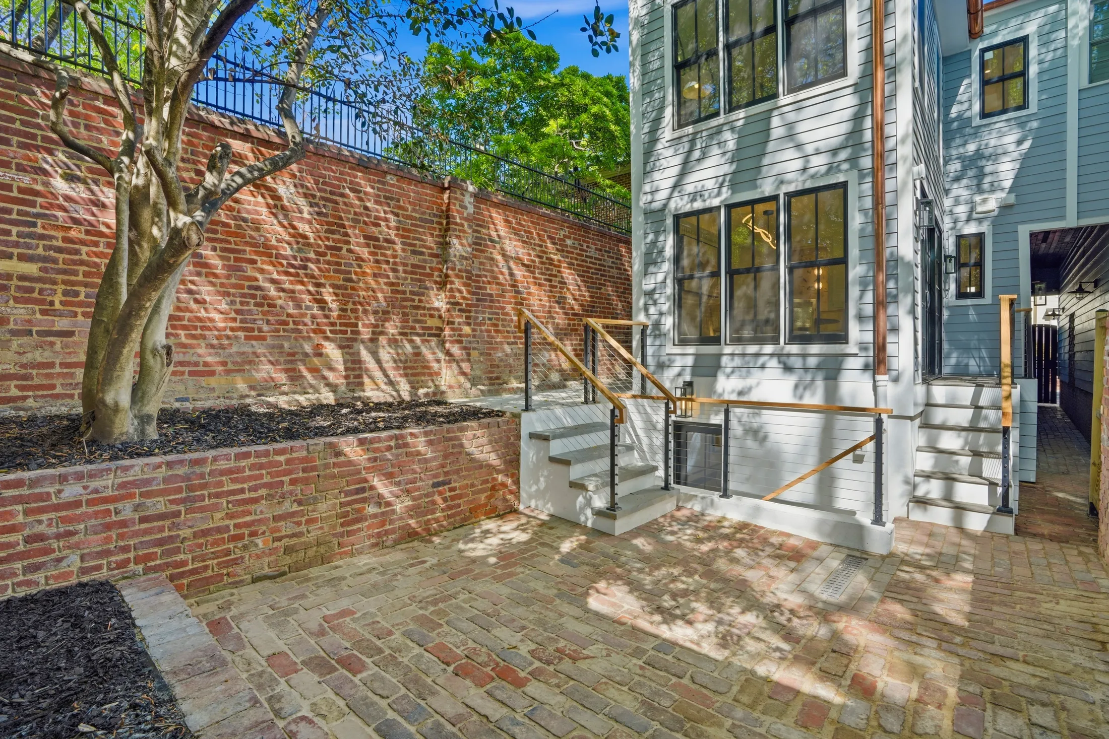 Brick-walled garden courtyard and rear façade at Casa Ulivo